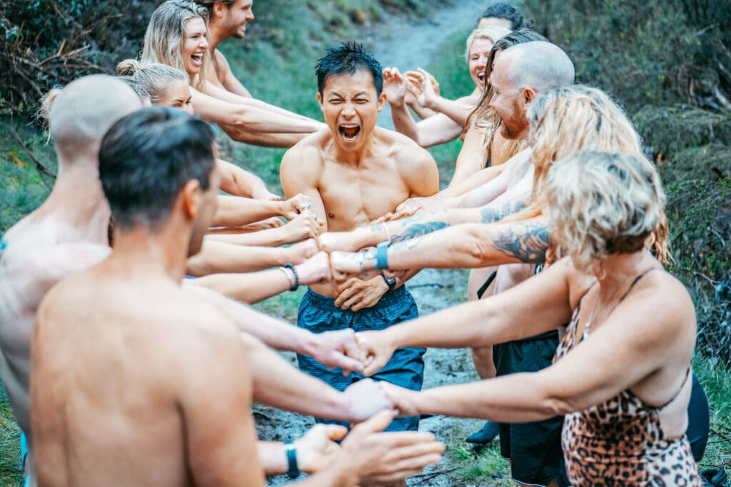 Breathwork Facilitator runs and high fives with other Breathwork trainers