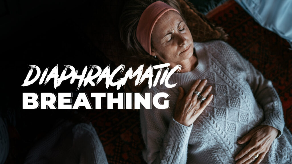 a women laying on the ground practicing diaphragmatic breathing