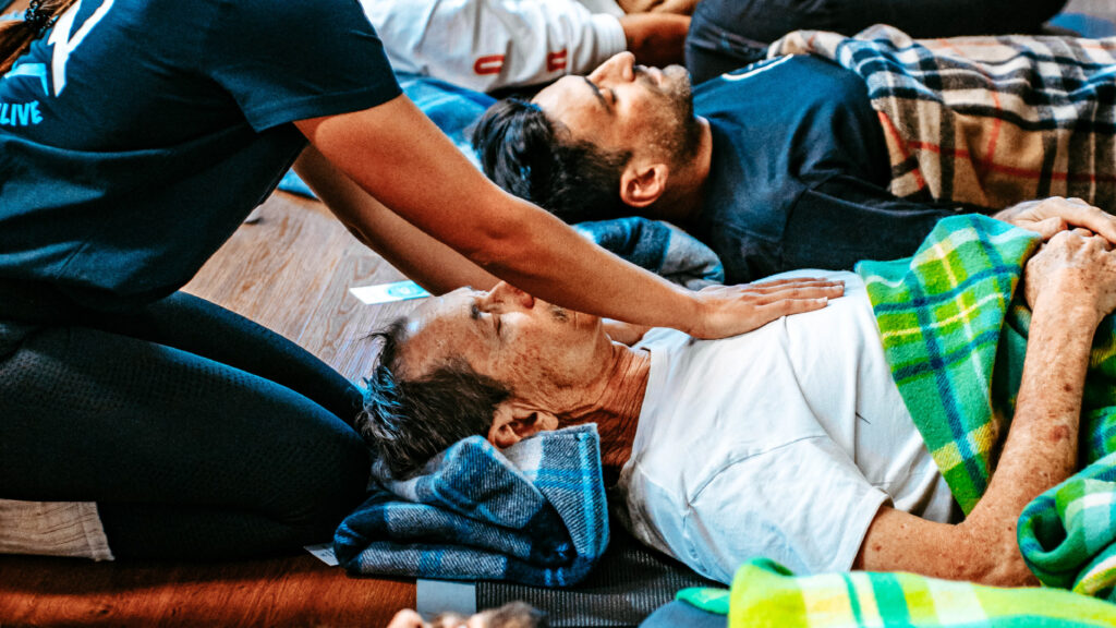 a man lying on the floor with another man on his chest
