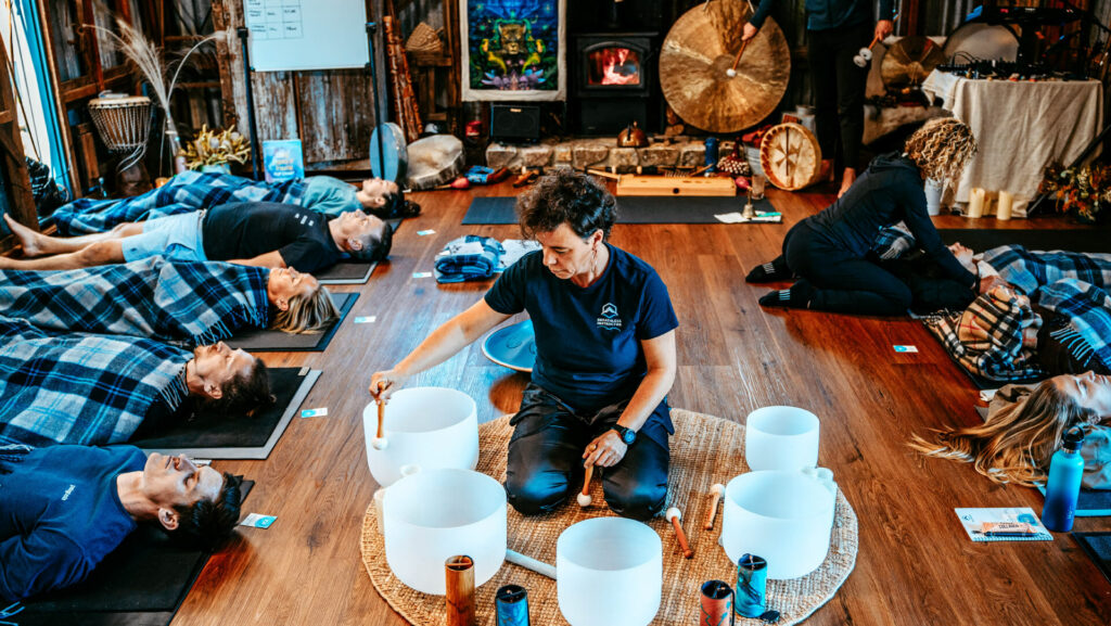 A breathwork facilitator conducting a sound bath.