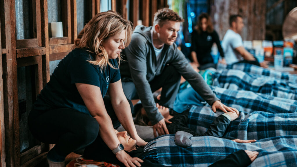 A group of people facilitating a breathwork workshop