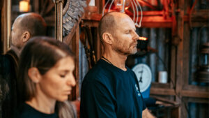 2 People sitting down practicing breathing to increase their heart rate variability